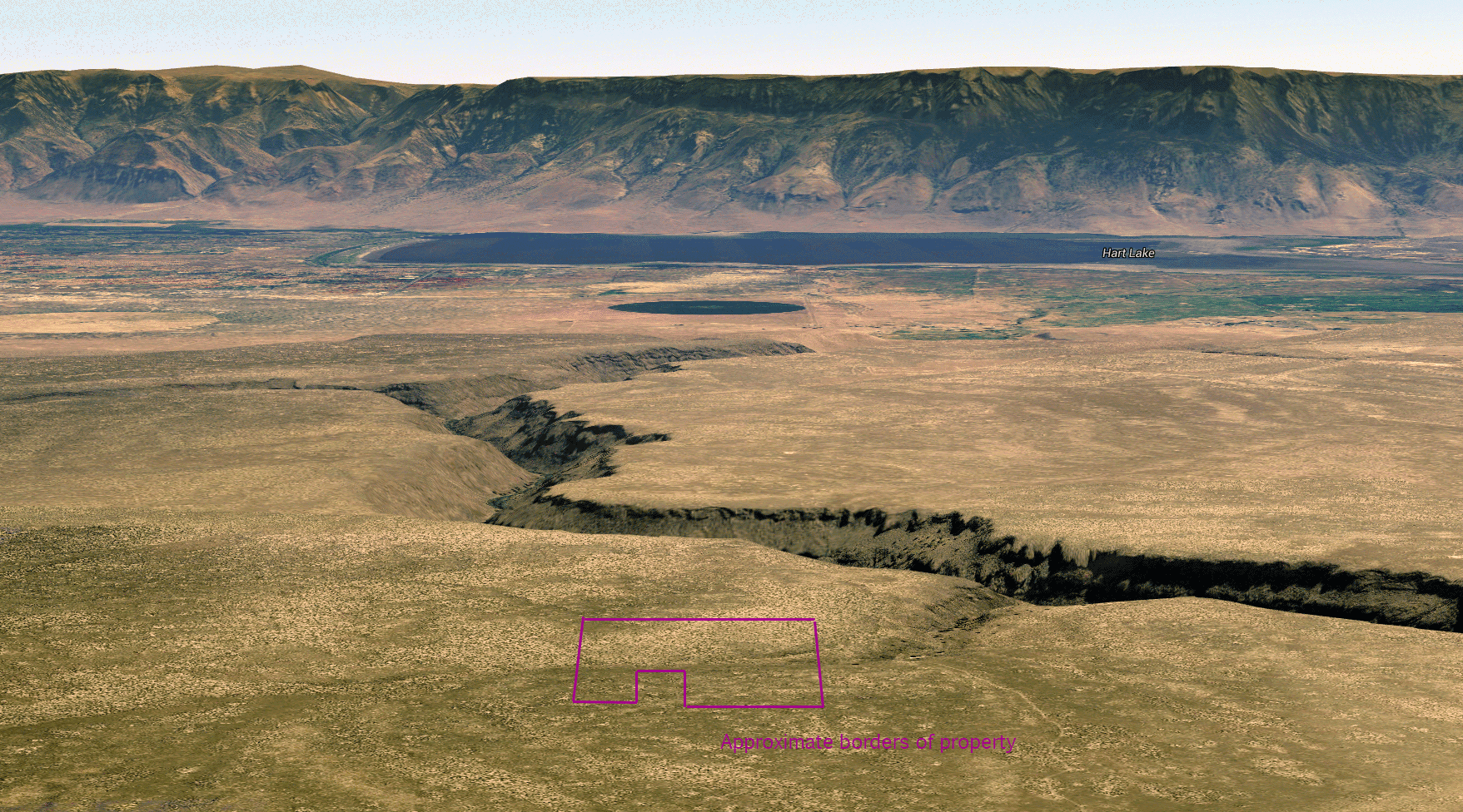 Oblique aerial view of Honey Creek and Hart Lake with approximate property borders