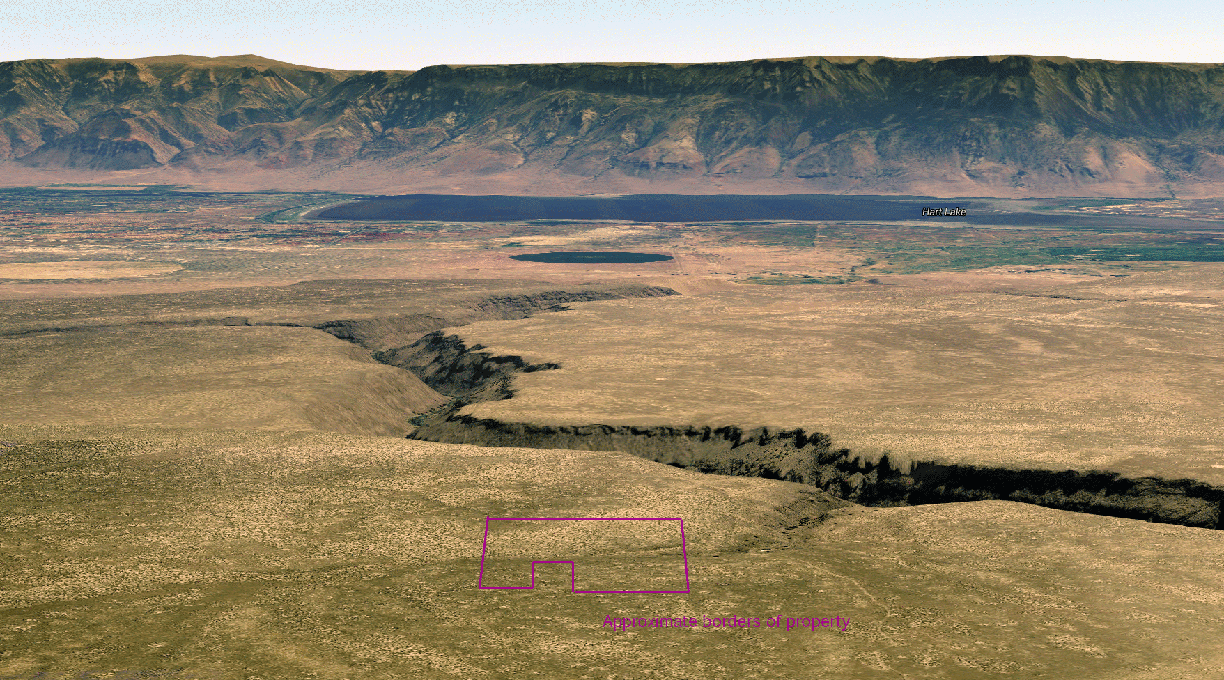 Oblique aerial view of Honey Creek and Hart Lake with approximate property borders