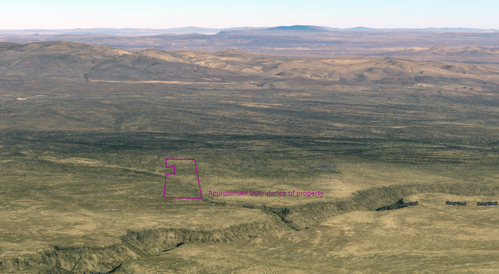 Oblique aerial view looking north toward Coyote Hills, with the parcel in purple above Honey Creek